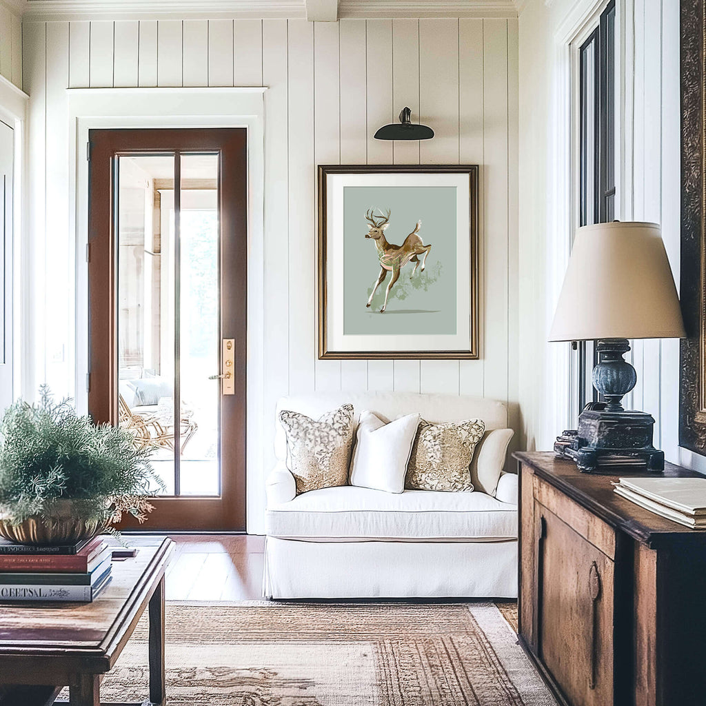 deer print on the wall in a frame in a keeping room with vertical shiplap walls and wood furniture with a white setee