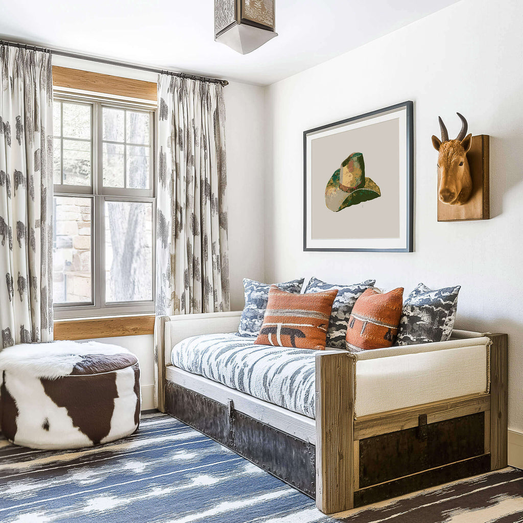 a cowboy boy's room with southwestern fabric patterns and a framed cowboy hat drawing on the wall