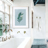 mosern coastal bathroom with light blue palm leaf art