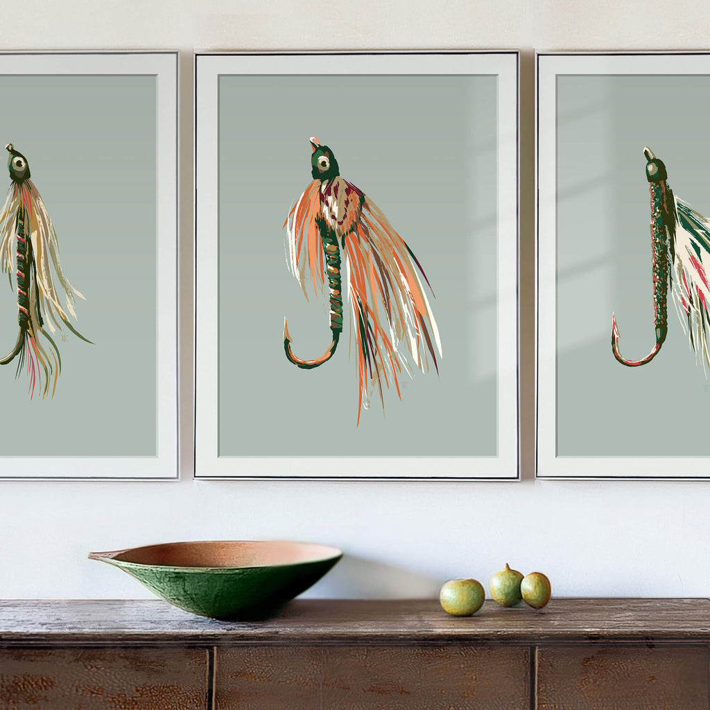 fishing fly painting set in frames, hanging above a weathered wood entryway table