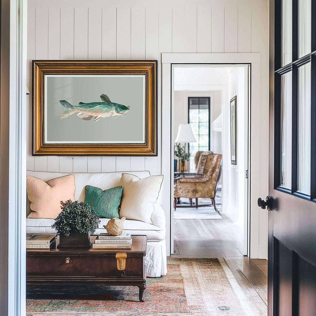 a sitting room with lake house decor, the walls are vertical shiplap and there is a catfish drawing in a frame on the wall above the sofa