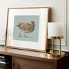 grey partridge artwork in a brass gold frame, gray