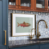 framed painting of a king salmon in a renovated kitchen of a lake house