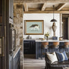 kitchen in a high end rustic mountain house with a framed wolf print over the counter