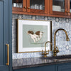 springer spaniel artwork in brass gold frame in a designer kitchen with blue Moroccan tile backsplash