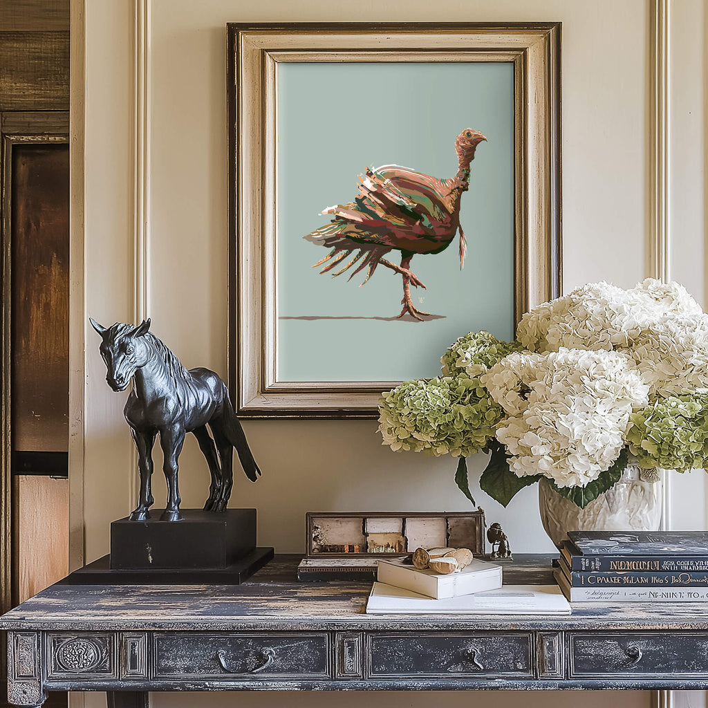 framed turkey drawing above a wooden entryway table. there is a horse sculpture and some flowers on the table
