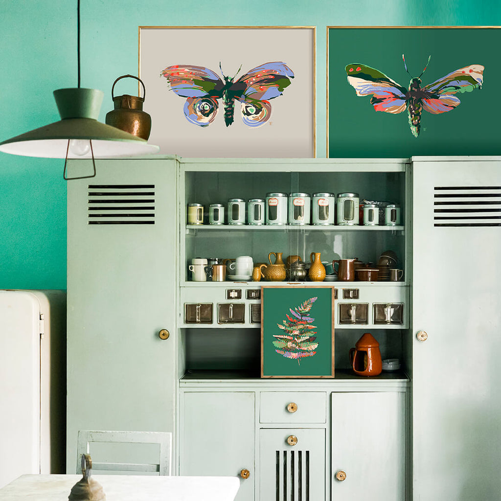 green vintage kitchen with moth paintings